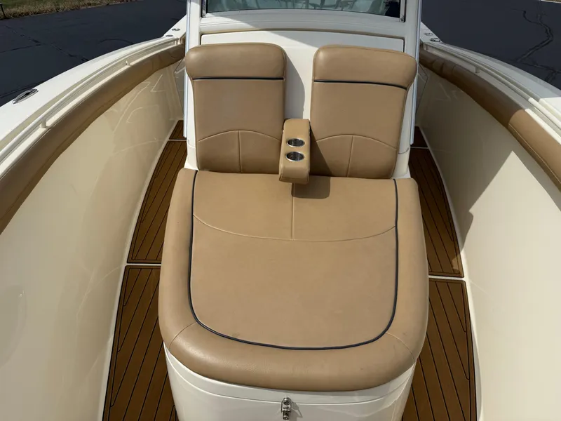 Slide: The Image of 2016 Scout 300 LXF boat interior with tan leather seating and cup holders. - 19