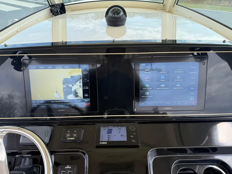 Slide: The Image of 2016 Scout 300 LXF dashboard with dual navigation screens and controls. - 26