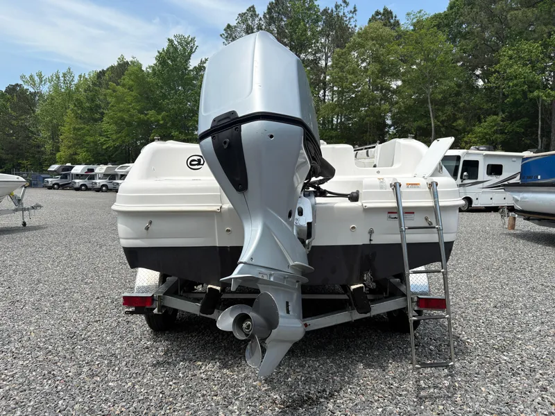 Slide: The Image of 2021 Hurricane Center Console SS 231 OB boat with outboard motor, parked on gravel. - 13