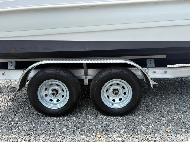 Slide: The Image of Trailer wheels of a 2021 Hurricane Center Console SS 231 OB boat on gravel. - 16