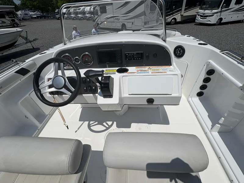 Slide: The Image of 2021 Hurricane Center Console SS 231 OB boat interior with steering wheel and control panel. - 7