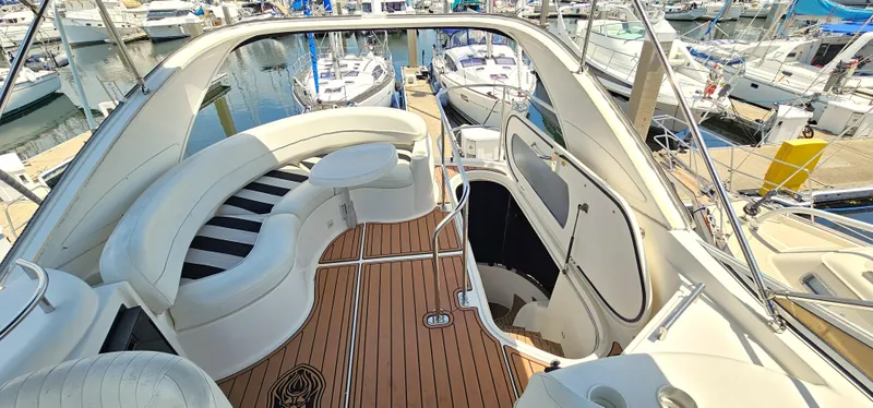 Slide: The Image of 2007 Meridian 341 Sedan yacht with elegant seating and wooden deck at a marina. - 16