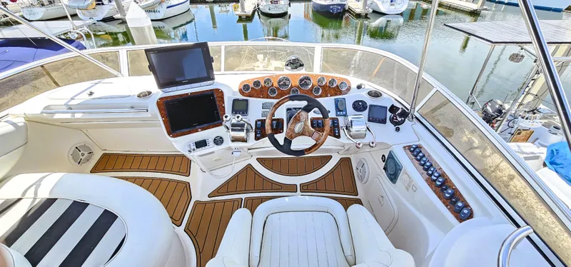 Slide: The Image of 2007 Meridian 341 Sedan yacht cockpit with steering wheel, navigation screens, and marina view. - 19