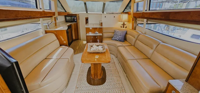 Slide: The Image of Luxurious interior of 2007 Meridian 341 Sedan yacht with leather seating and wooden accents. - 2