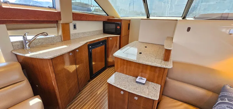 Slide: The Image of 2007 Meridian 341 Sedan interior with wood cabinetry, kitchenette, and seating area. - 6