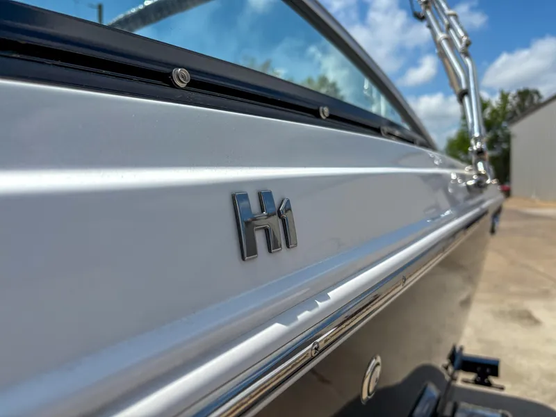 Slide: The Image of 2023 Four Winns H1 boat side view with logo, showcasing sleek design. - 2