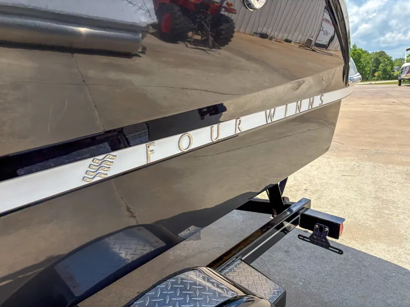 Slide: The Image of 2023 Four Winns H1 boat on trailer, close-up of sleek hull design. - 3