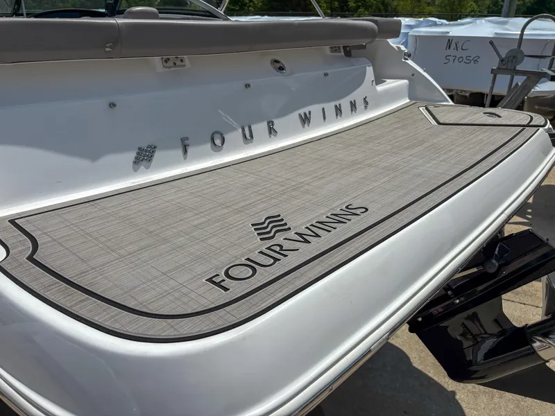 Slide: The Image of 2023 Four Winns H1 boat with branded swim platform in sunlight. - 5