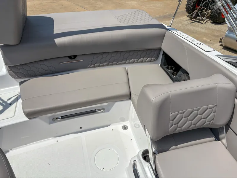 Slide: The Image of 2023 Four Winns H1 boat interior with gray cushioned seating and textured design. - 6