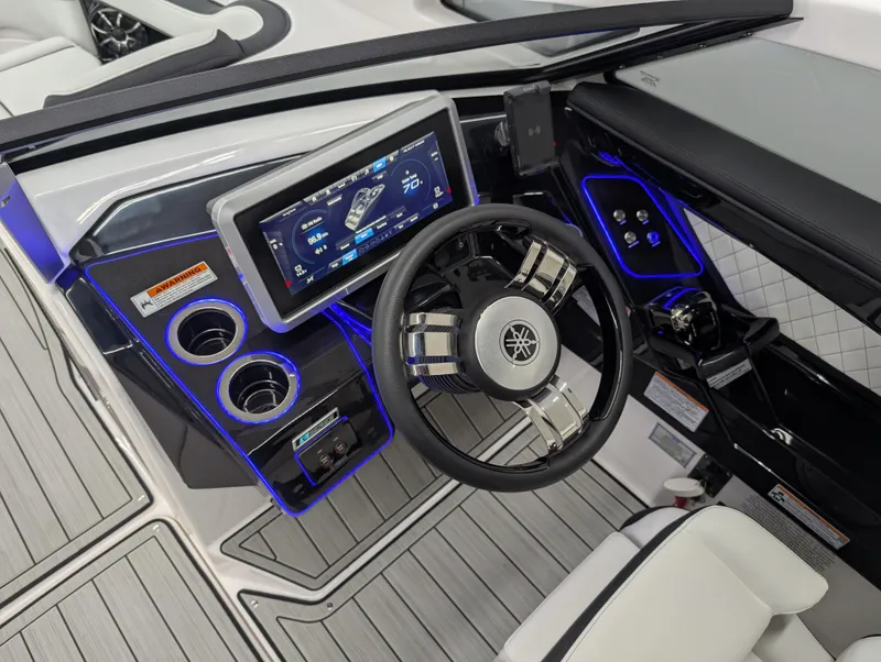 Slide: The Image of 2024 Yamaha Boats 275 SE dashboard with touchscreen, steering wheel, and illuminated controls. - 11