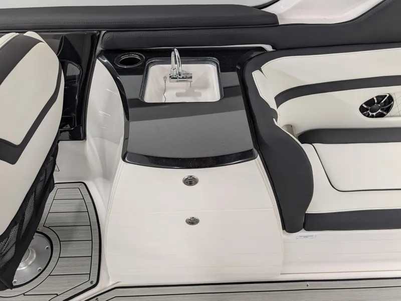 Slide: The Image of 2024 Yamaha Boats 275 SE interior with sleek seating and built-in sink. - 16