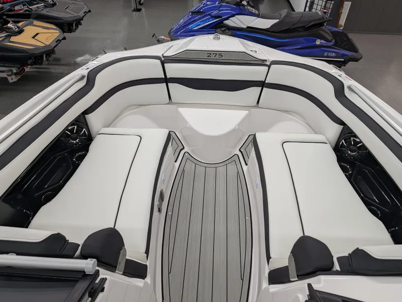 Slide: The Image of 2024 Yamaha Boats 275 SE interior with sleek white seating and modern design. - 7