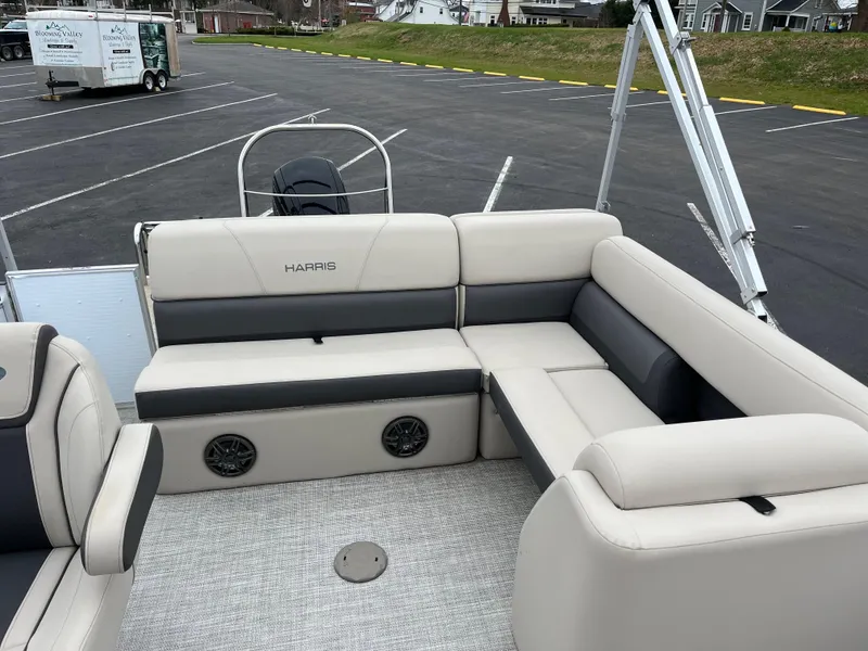 Slide: The Image of 2022 Harris Cruiser 230 boat interior with beige seating and steering wheel. - 5
