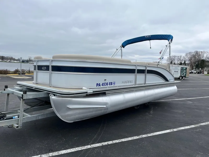 Slide: The Image of 2022 Harris Cruiser 230 pontoon boat on trailer in parking lot. - 7