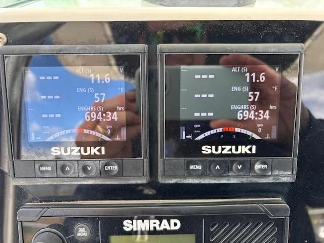 Slide: The Image of Close-up of Suzuki engine displays on a 2009 Robalo R240 Center Console boat. - 10