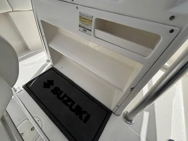 Slide: The Image of 2009 Robalo R240 Center Console interior with Suzuki mat and storage compartments. - 13