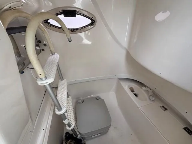 Slide: The Image of 2009 Robalo R240 Center Console interior with ladder and portable toilet. - 14
