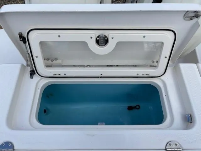 Slide: The Image of 2009 Robalo R240 Center Console livewell with open lid, showcasing interior. - 15