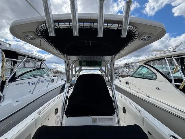 Slide: The Image of 2009 Robalo R240 Center Console boat docked between two other boats. - 16