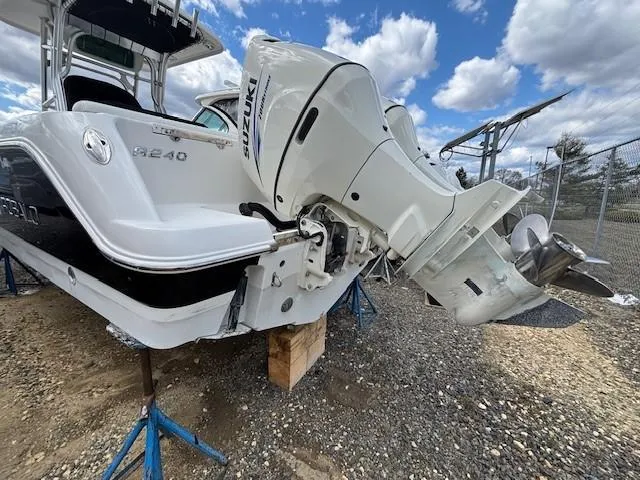 Slide: The Image of 2009 Robalo R240 Center Console boat with Suzuki outboard motor on stands. - 3