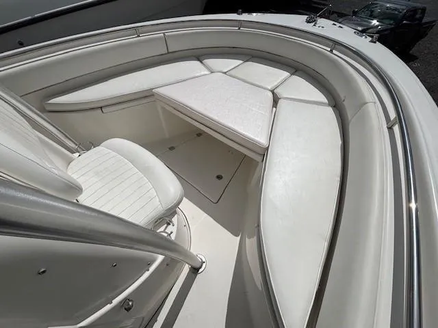 Slide: The Image of 2009 Robalo R240 Center Console boat with white cushioned seating area. - 5