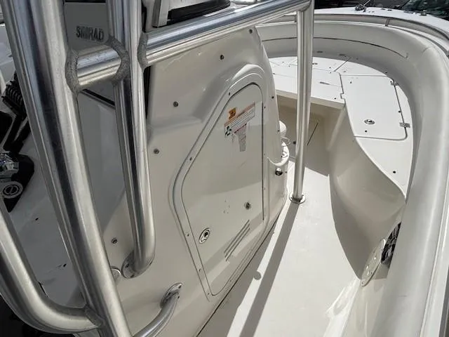 Slide: The Image of 2009 Robalo R240 Center Console boat interior with white deck and storage compartment. - 6