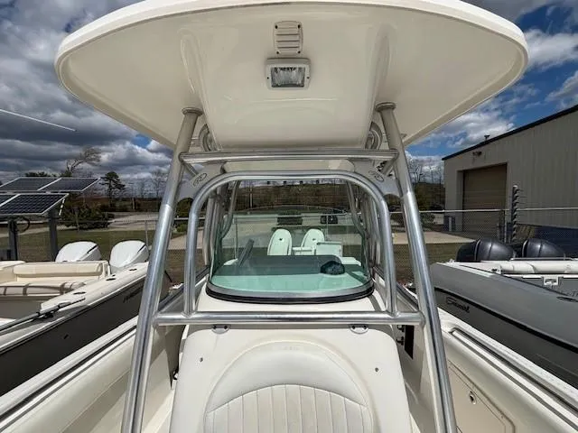 Slide: The Image of 2009 Robalo R240 Center Console boat with T-top and seating, docked outdoors. - 8