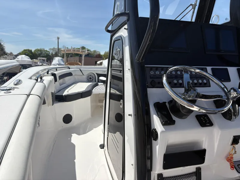 Slide: The Image of 2023 Tidewater 272 LXF boat interior with steering wheel and seating area. - 5