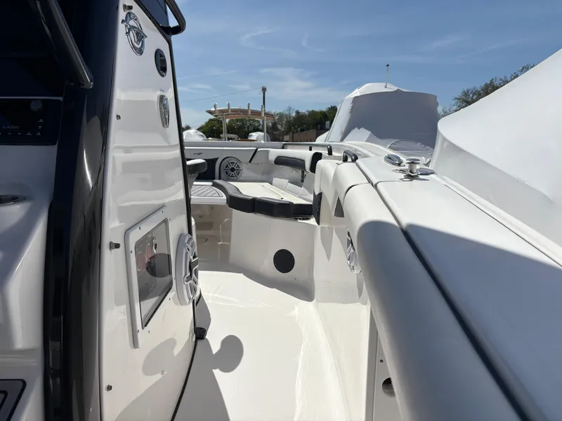 Slide: The Image of 2023 Tidewater 272 LXF boat interior with sleek white design and seating area. - 6