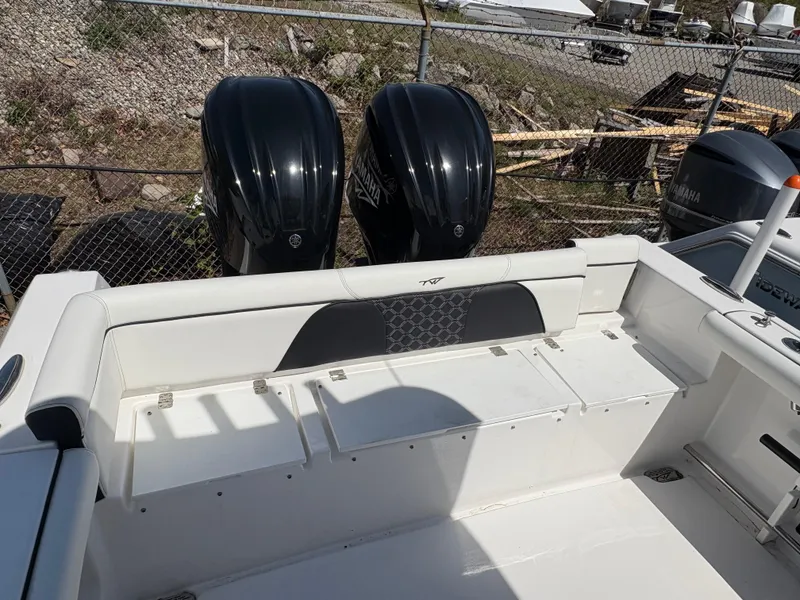 Slide: The Image of 2023 Tidewater 272 LXF boat with dual outboard engines and spacious seating area. - 8