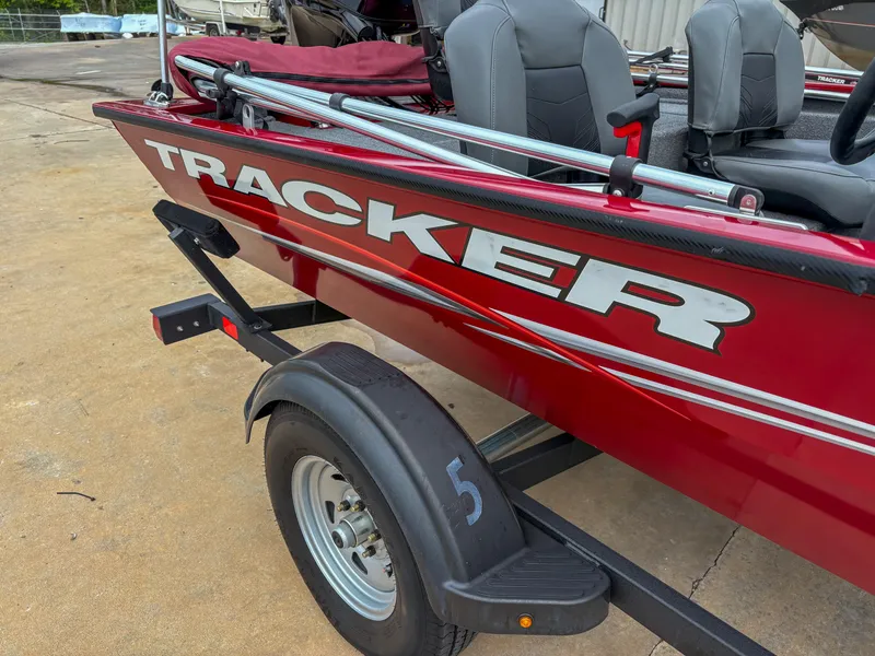Slide: The Image of 2024 Tracker Pro 170 boat on trailer, red exterior, parked on concrete surface. - 5