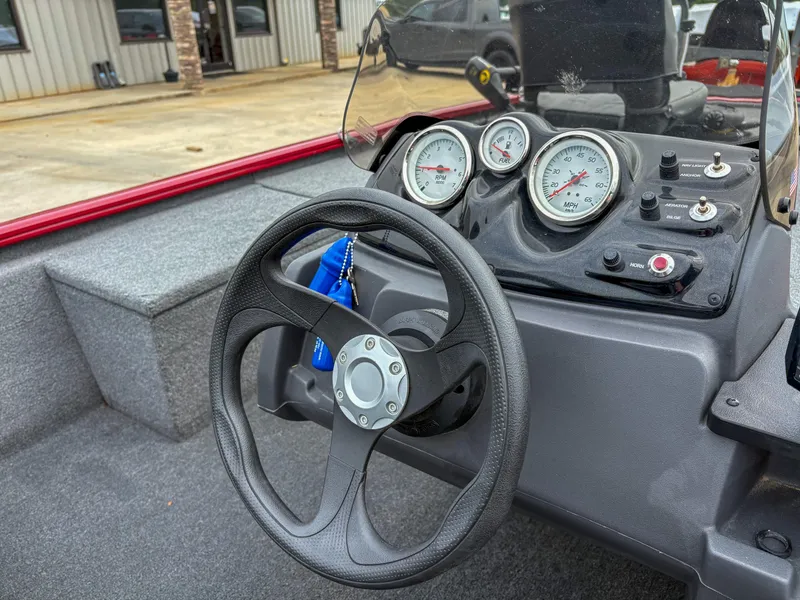 Slide: The Image of 2024 Tracker Pro 170 boat dashboard with steering wheel and gauges. - 7
