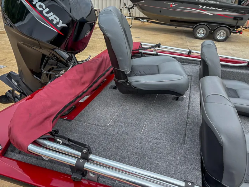 Slide: The Image of 2024 Tracker Pro 170 boat interior with Mercury engine and gray seating. - 9