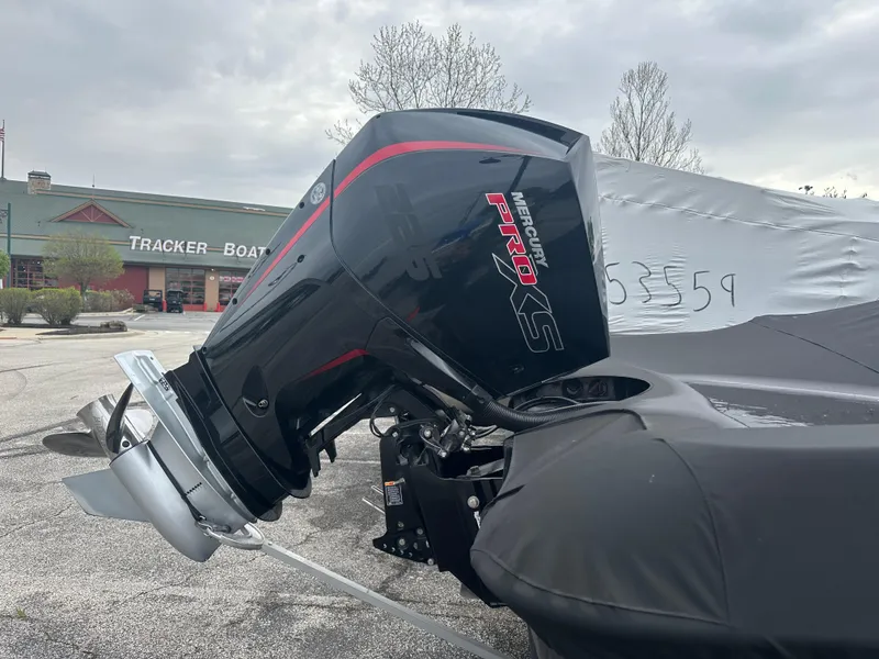 Slide: The Image of 2023 Nitro ZV19 Pro boat with Mercury Pro XS engine, covered and parked outdoors. - 3