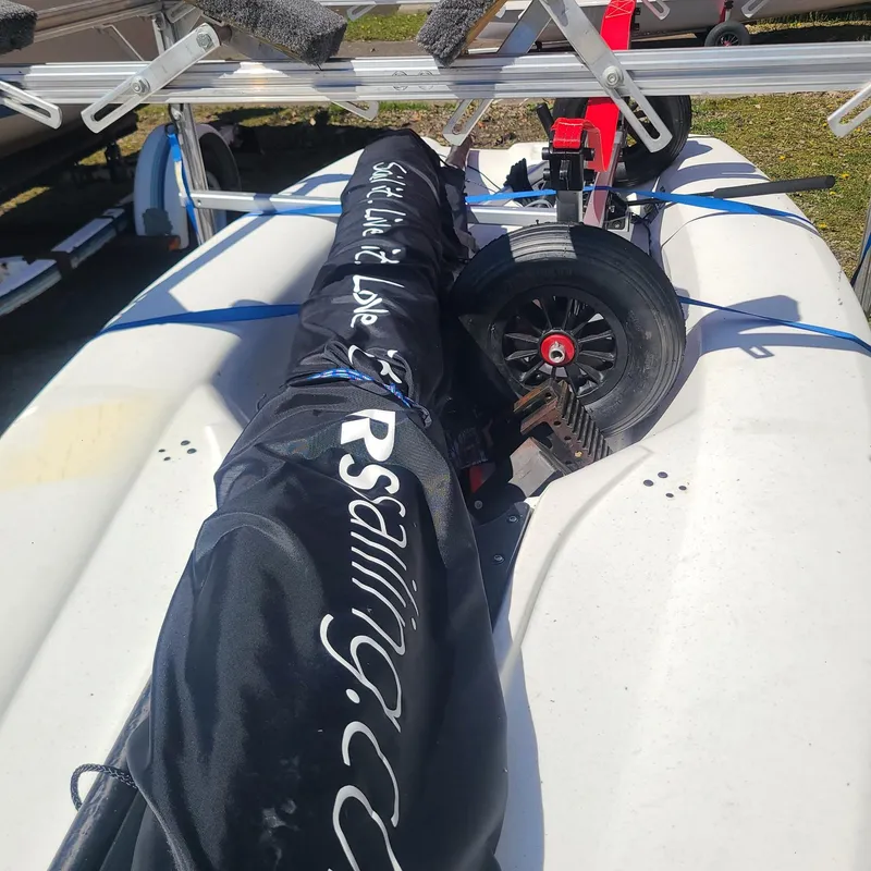 Slide: The Image of 2017 RS Neo sailboat with covered mast and dolly on trailer. - 3