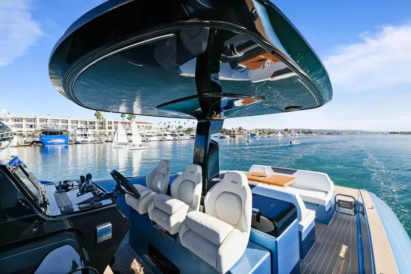 Slide: The Image of 2023 Solaris Power 40 Open yacht with luxurious seating, docked in a scenic marina. - 16