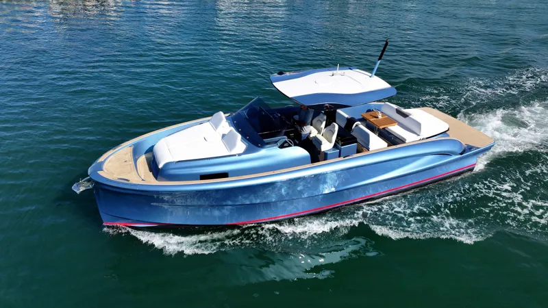 Slide: The Image of 2023 Solaris Power 40 Open yacht cruising on clear blue water. - 5