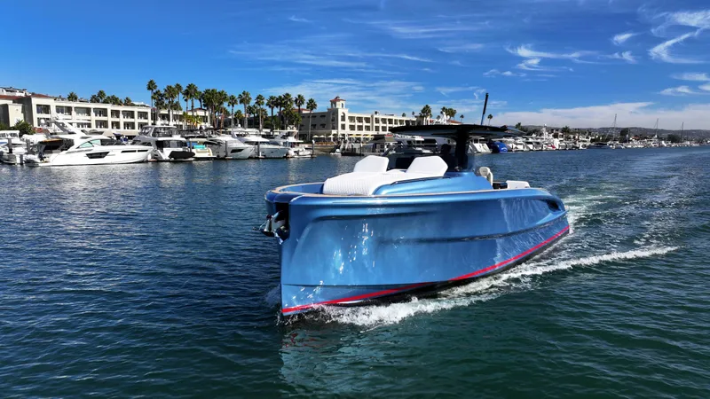 Slide: The Image of 2023 Solaris Power 40 Open yacht cruising in a marina with palm trees and buildings. - 7