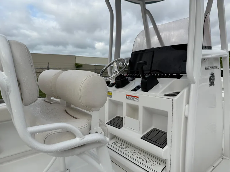 Slide: The Image of 2021 Sea Hunt Ultra 219 boat console with steering wheel and seating. - 10