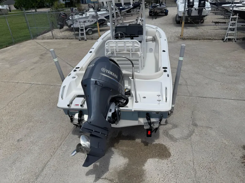 Slide: The Image of 2021 Sea Hunt Ultra 219 boat with Yamaha outboard motor, parked on concrete. - 14