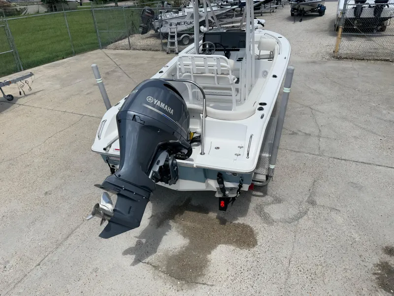 Slide: The Image of 2021 Sea Hunt Ultra 219 boat with Yamaha outboard motor, parked on concrete. - 15