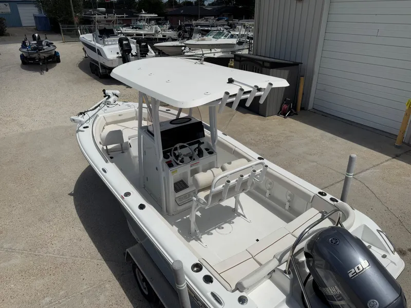 Slide: The Image of 2021 Sea Hunt Ultra 219 boat with Yamaha 200 engine, parked in a marina. - 17