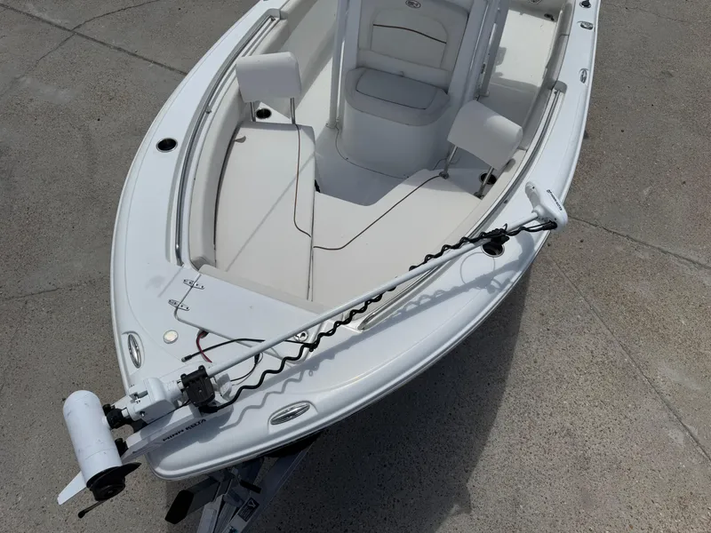 Slide: The Image of 2021 Sea Hunt Ultra 219 boat with trolling motor on concrete surface. - 19