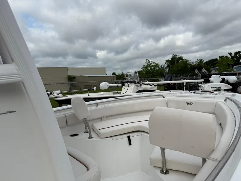 Slide: The Image of 2021 Sea Hunt Ultra 219 boat interior with seating under cloudy sky. - 21