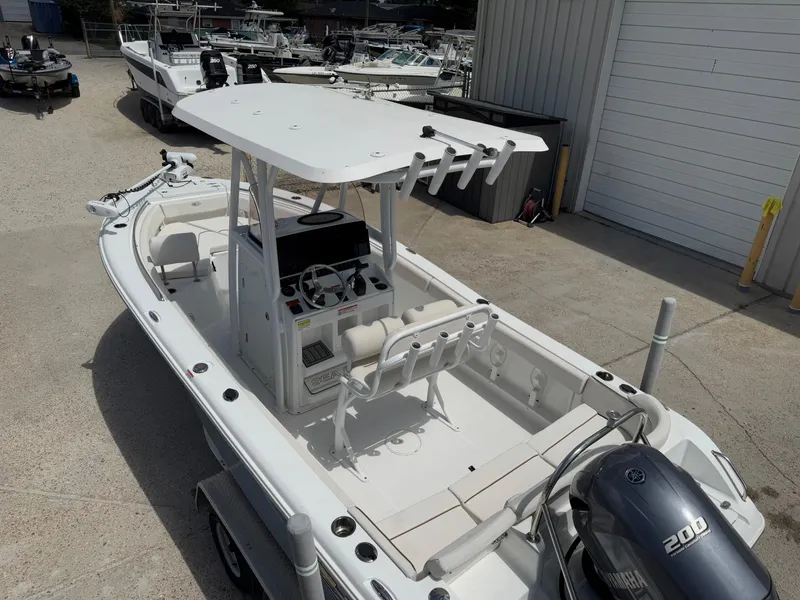 Slide: The Image of 2021 Sea Hunt Ultra 219 boat with Yamaha 200 engine, docked at a marina. - 24