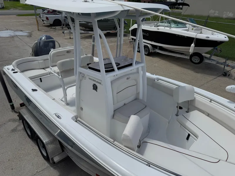 Slide: The Image of 2021 Sea Hunt Ultra 219 boat on trailer, featuring spacious seating and modern design. - 28