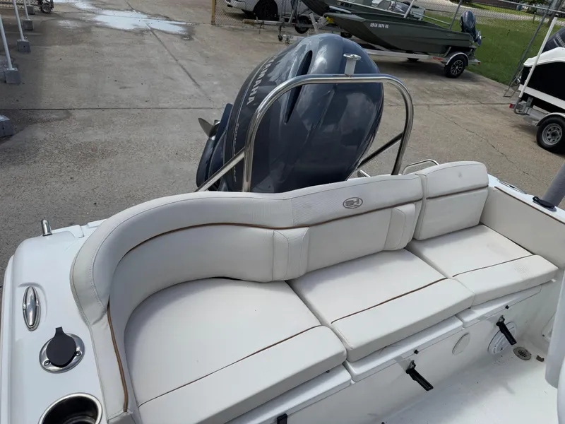 Slide: The Image of 2021 Sea Hunt Ultra 219 boat with white seating and Yamaha outboard motor. - 29