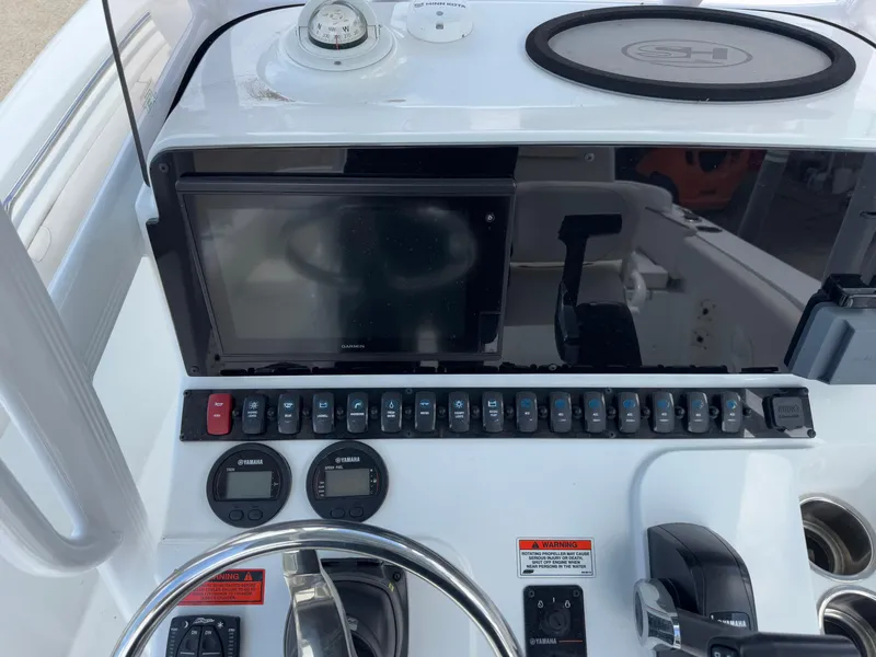 Slide: The Image of 2021 Sea Hunt Ultra 219 dashboard with Garmin display and Yamaha controls. - 30