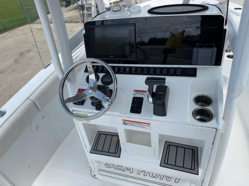 Slide: The Image of 2021 Sea Hunt Ultra 219 boat console with steering wheel and controls. - 32