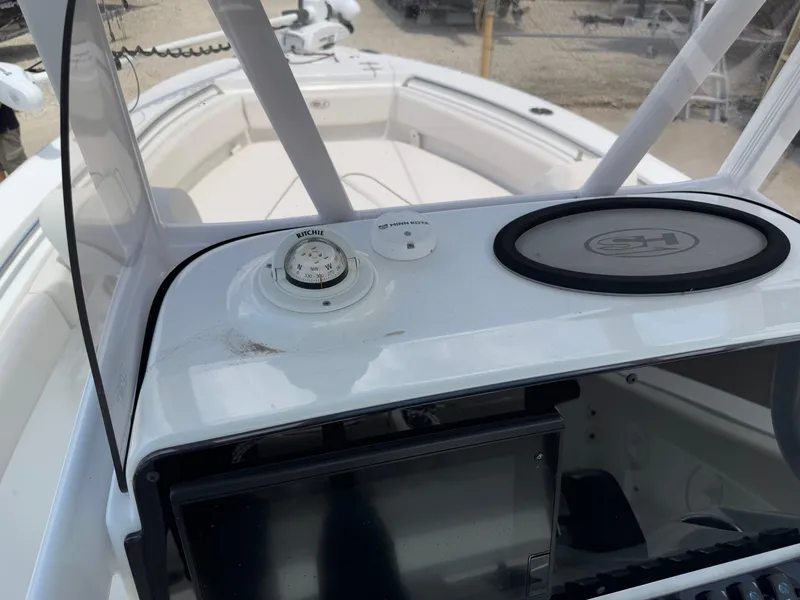Slide: The Image of 2021 Sea Hunt Ultra 219 boat dashboard with compass and control panel. - 33